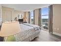 Bright bedroom with large windows and views of the surrounding area and hardwood floors at 2301 S Ocean Blvd. # 1401, North Myrtle Beach, SC 29582