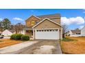 Attractive home with a two-car garage, vinyl siding, brick facade, and neat landscaping at 233 Carolina Farms Blvd., Myrtle Beach, SC 29579