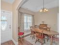 Elegant dining room with wood table, chairs, and a decorative light fixture, perfect for Gathering gatherings at 256 Maple Oak Dr., Conway, SC 29526