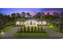 Lovely home with manicured lawn, palm trees, circular drive and stone detailing on facade at 2849 Old Bryan Dr., Myrtle Beach, SC 29577