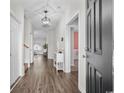 Entryway hallway featuring hardwood floors and a decorative light fixture at 349 Lakota Loop, Longs, SC 29568