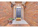 Charming front entryway featuring a brick facade, decorative lighting, and a welcoming door at 3791 Cagney Ln., Myrtle Beach, SC 29577