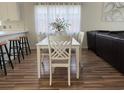 Bright dining area with a white table and chairs, adjacent to the kitchen and living room at 3955 Gladiola Ct. # 301, Myrtle Beach, SC 29588