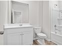 Cozy, clean bathroom featuring a shower-tub combo, toilet, and a vanity with a large mirror at 409 Falling Leaf Loop, Myrtle Beach, SC 29588