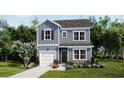 Charming two-story home featuring blue siding, black shutters, and a well-manicured front lawn at 409 Falling Leaf Loop, Myrtle Beach, SC 29588