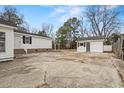 Exterior view of backyard with two-car detached garage and storage building at 410 Martin St., Mullins, SC 29574