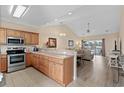 Bright open kitchen with stainless steel appliances and wood cabinets at 4140 Hibiscus Dr. # 303, Little River, SC 29566