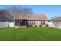 Back exterior featuring a screened in porch, green lawn, and vinyl siding at 422 Cassian Way, Myrtle Beach, SC 29588