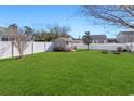 Expansive, well-maintained backyard featuring a white fence and a storage shed at 422 Cassian Way, Myrtle Beach, SC 29588