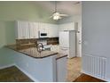 Bright kitchen with white cabinetry, granite countertops, and stainless steel appliances at 422 Cassian Way, Myrtle Beach, SC 29588