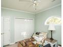 Bedroom with white trim, light green walls, closet, ceiling fan, and a half-moon window at 4220 Coquina Harbour Dr. # B-12, Little River, SC 29566