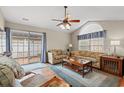 Bright living room with a ceiling fan, hardwood floors, and sliding glass doors leading to patio at 4309 River Gate Ln., Little River, SC 29566