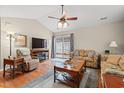 Inviting living room with a ceiling fan, hardwood floors, and sliding glass doors to outdoor space at 4309 River Gate Ln., Little River, SC 29566