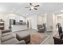 Bright living room showcasing an open concept layout, gray floors and a ceiling fan at 453 Rycola Circle, Surfside Beach, SC 29575