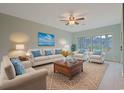 Bright living room featuring a comfortable seating arrangement and large windows at 48 Twelve Oaks Dr. # 2, Pawleys Island, SC 29585