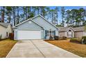 Inviting home featuring attached two-car garage, blue siding and neatly trimmed landscaping at 6494 Royal Pine Dr., Myrtle Beach, SC 29588