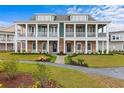 Beautiful two-story townhome with landscaped pathway and double balconies and a green and white paint scheme at 8035 Arcady St. # B, Myrtle Beach, SC 29572