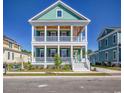 Charming two-story home with a double porch featuring a stylish green exterior at 8079 Laurel Ash Ave., Myrtle Beach, SC 29572