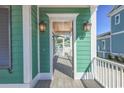 View of a covered porch, showcasing wood ceiling details and elegant lighting fixtures at 8079 Laurel Ash Ave., Myrtle Beach, SC 29572