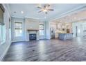 Open-concept living room featuring a fireplace and hardwood floors connecting to the kitchen at 8079 Laurel Ash Ave., Myrtle Beach, SC 29572