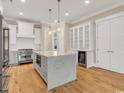 Bright, modern kitchen with stainless steel appliances, a large island, and custom cabinetry at 8156 Living Tide Dr., Myrtle Beach, SC 29572