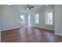 Bright and airy living room features hardwood floors, crown molding, and lots of natural light at 8156 Living Tide Dr., Myrtle Beach, SC 29572