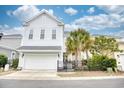 Bright two-story home with a spacious two-car garage and well-maintained yard with lovely palm trees at 843 Howard Ave., Myrtle Beach, SC 29577