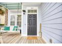 Classic-style front door with a welcoming porch swing, creating an inviting entrance to the home at 843 Howard Ave., Myrtle Beach, SC 29577