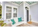 Inviting front porch featuring a cozy porch swing and charming coastal decor creating a relaxing outdoor space at 843 Howard Ave., Myrtle Beach, SC 29577