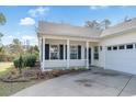 Inviting front porch with white railing and black shutters, leading to a well-lit home entrance at 10-1 Rattan Circle # 1, Pawleys Island, SC 29585