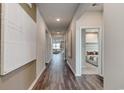 Long hallway with wood floors leads into a bedroom and living room with neutral decor at 1030 Laconic Dr., Myrtle Beach, SC 29588