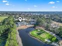 Aerial view showcases condos, a pond, and a golf course, with scenic community surroundings at 131 Greenside Villas Dr. # B10, Little River, SC 29566