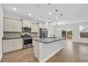 Spacious kitchen featuring stainless steel appliances, a granite island, and modern pendant lighting at 145 Goldenrod Circle # 7B, Little River, SC 29566