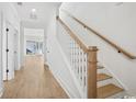 Bright, modern staircase featuring wood treads, white risers and walls, and minimalist design at 1800 Tryon Dr, Myrtle Beach, SC 29588