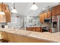 Spacious kitchen featuring granite countertops, stainless steel appliances, and wood cabinetry at 1822 Topsail Ln., North Myrtle Beach, SC 29582