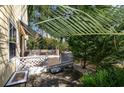 Charming back porch with lattice railing and a cozy seating area, shaded by lush greenery at 2120 Adams Way, Little River, SC 29566