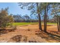 Scenic view of a lush green golf course, framed by mature trees and clear blue skies at 2450 Marsh Glen Dr. # 812, North Myrtle Beach, SC 29582