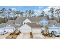 An aerial view of charming townhomes with double garages, lovely landscaping, and ample parking spaces at 2475 Blue Crane Circle # 103, Myrtle Beach, SC 29577