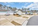 Street view showcases townhomes with double garages, driveways, landscaping, and varied exterior colors at 2475 Blue Crane Circle # 103, Myrtle Beach, SC 29577