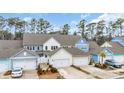 Lovely townhomes with double garages and beautiful landscaping; a wonderful aerial view at 2475 Blue Crane Circle # 103, Myrtle Beach, SC 29577