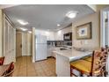 Bright kitchen featuring white cabinets, modern appliances, and a breakfast bar at 2501 S Ocean Blvd. # 601, Myrtle Beach, SC 29577