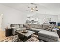 Spacious living room featuring a large sectional sofa, ceiling fan, and open concept layout at 281 Encore Circle, Myrtle Beach, SC 29579