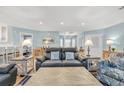 Comfortable living room with a leather sofa, coastal decor, light blue walls, and lots of natural light at 299 Lake Arrowhead Rd., Myrtle Beach, SC 29572