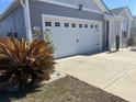 A well maintained garage on a home with well-manicured plants and a large driveway at 3009 Woodbury Ct., Conway, SC 29527