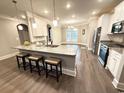 Bright kitchen with granite island, pendant lighting, and barstool seating overlooking the dining area at 311 Las Olas Dr., Myrtle Beach, SC 29577