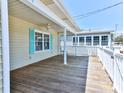 Large wooden deck offering a fantastic view and space for outdoor activities, with white railings at 317 23Rd Ave. N, North Myrtle Beach, SC 29582