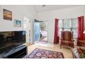 Bright living room with open door to entryway, carpet, and red curtains at 3567 Chestnut Dr. # 3567, Myrtle Beach, SC 29577