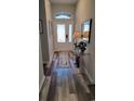 Bright foyer with a glass door, stylish wood floors, decorative table, mirror and decor at 372 Leste Rd., Myrtle Beach, SC 29588