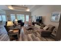 Spacious living room featuring neutral tones, plenty of seating, tray ceiling, and natural light at 372 Leste Rd., Myrtle Beach, SC 29588