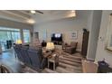 Comfortable living room showcasing tray ceiling, neutral paint, and open floor plan with a ceiling fan at 372 Leste Rd., Myrtle Beach, SC 29588